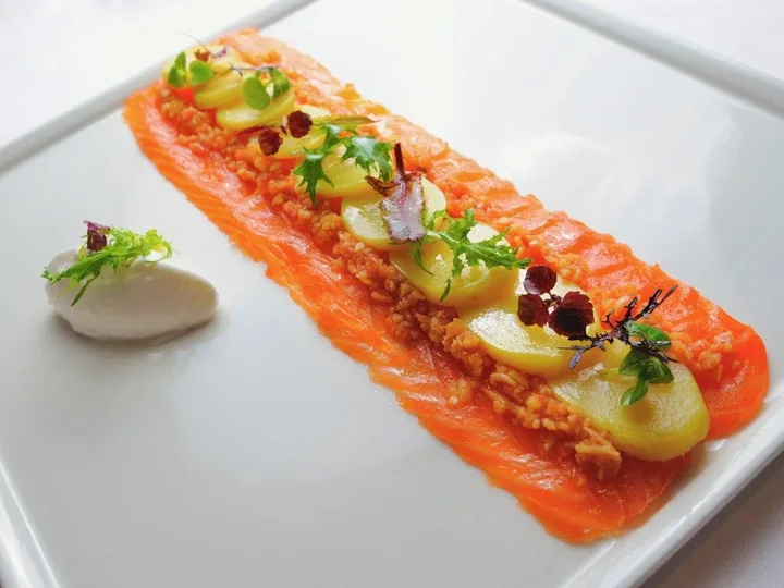 Saumon mariné en longueur, pommes de terre et jeunes pousses